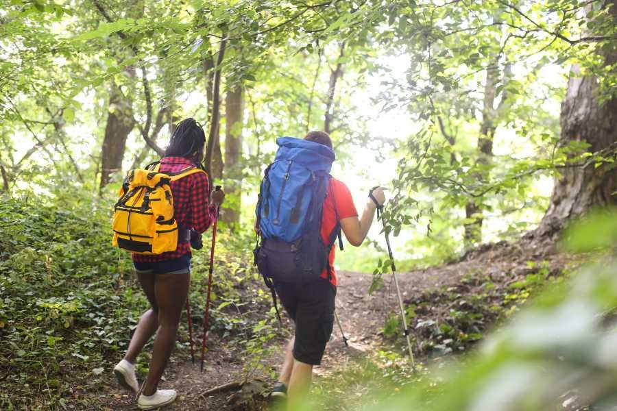 Two people are hiking in a mountainous area