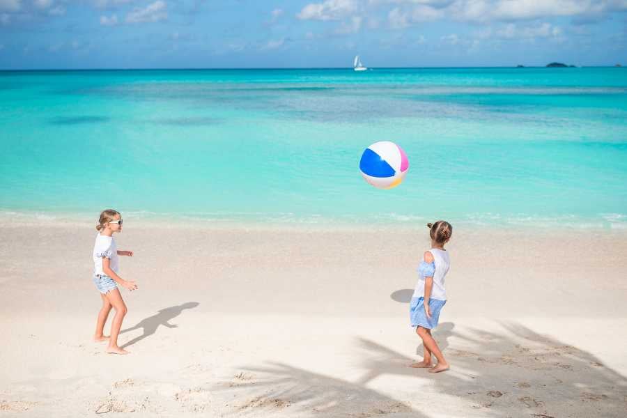 Two children are playing on the beach