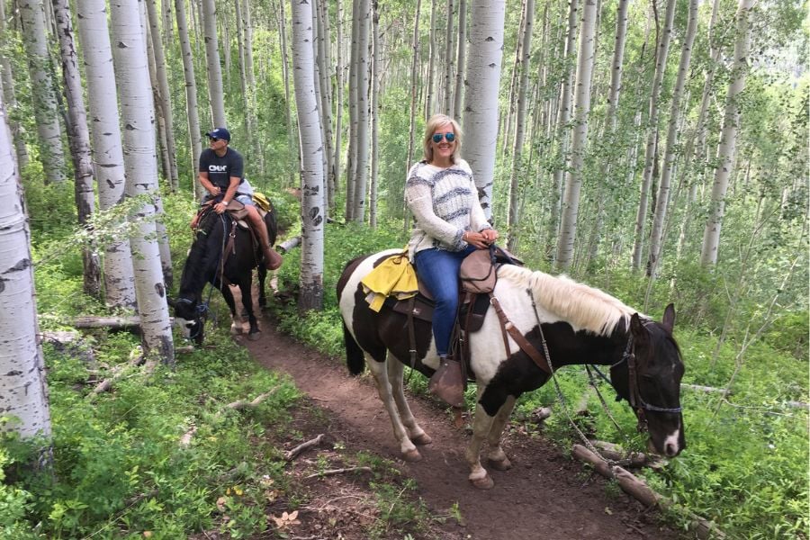 Riders wander peacefully through Vail’s shady aspen forests.