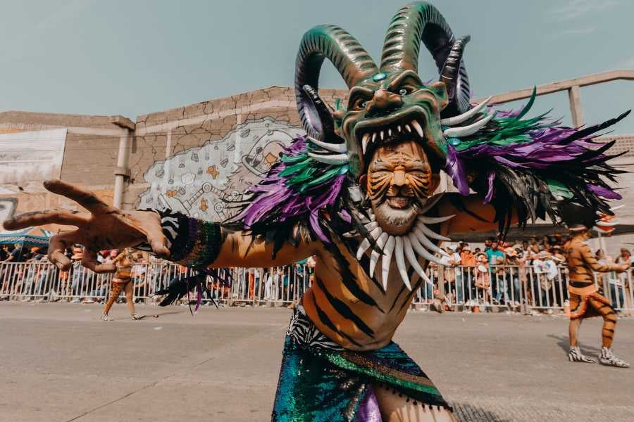 A lively carnival scene with a performer in a colorful, dramatic costume.