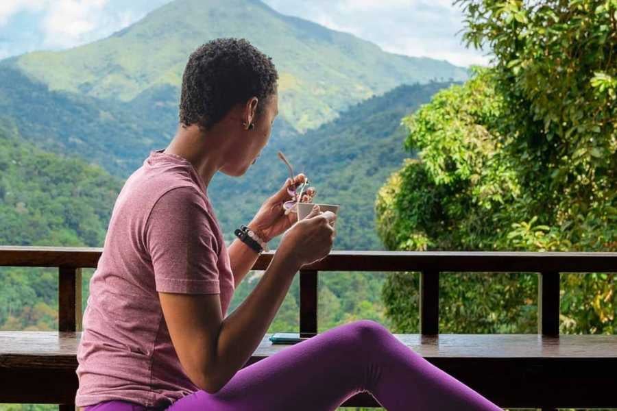 A woman enjoys a peaceful meal while soaking in the breathtaking mountain scenery.