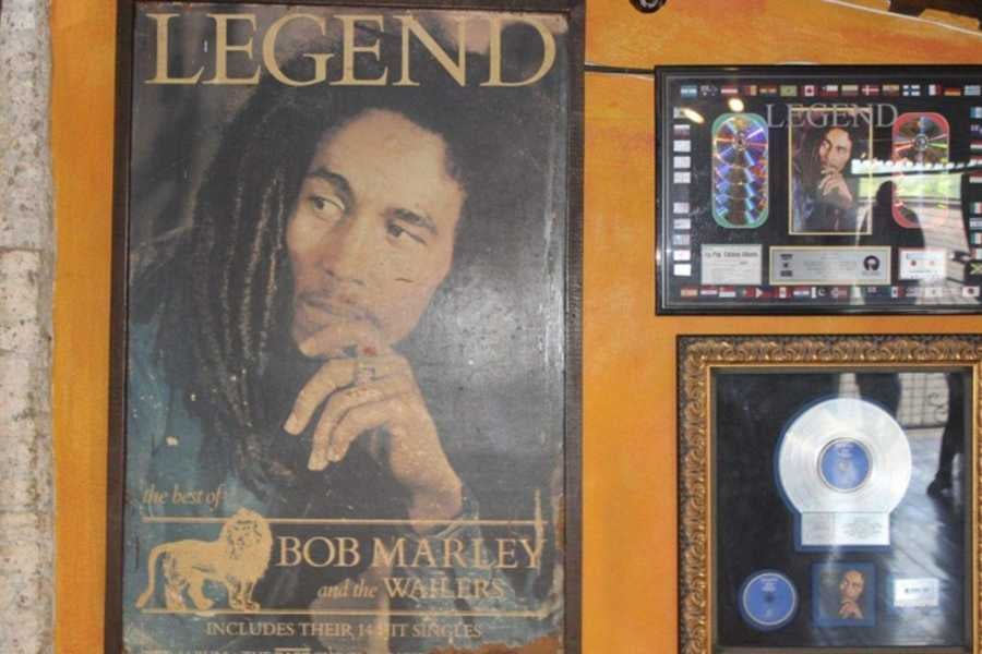 A framed Bob Marley poster and music memorabilia celebrate the legendary reggae artist’s impact.