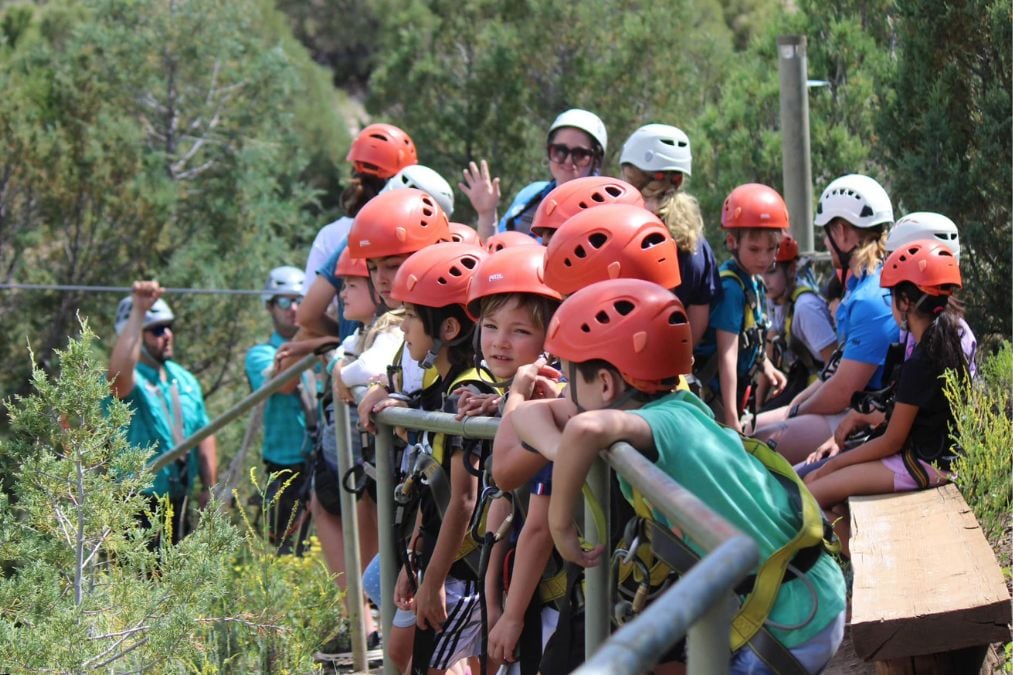 Kids wait excitedly for their turn on a zipline in Breckenridge.